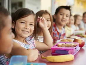 depositphotos_219742456-stock-photo-elementary-school-kids-sitting-table